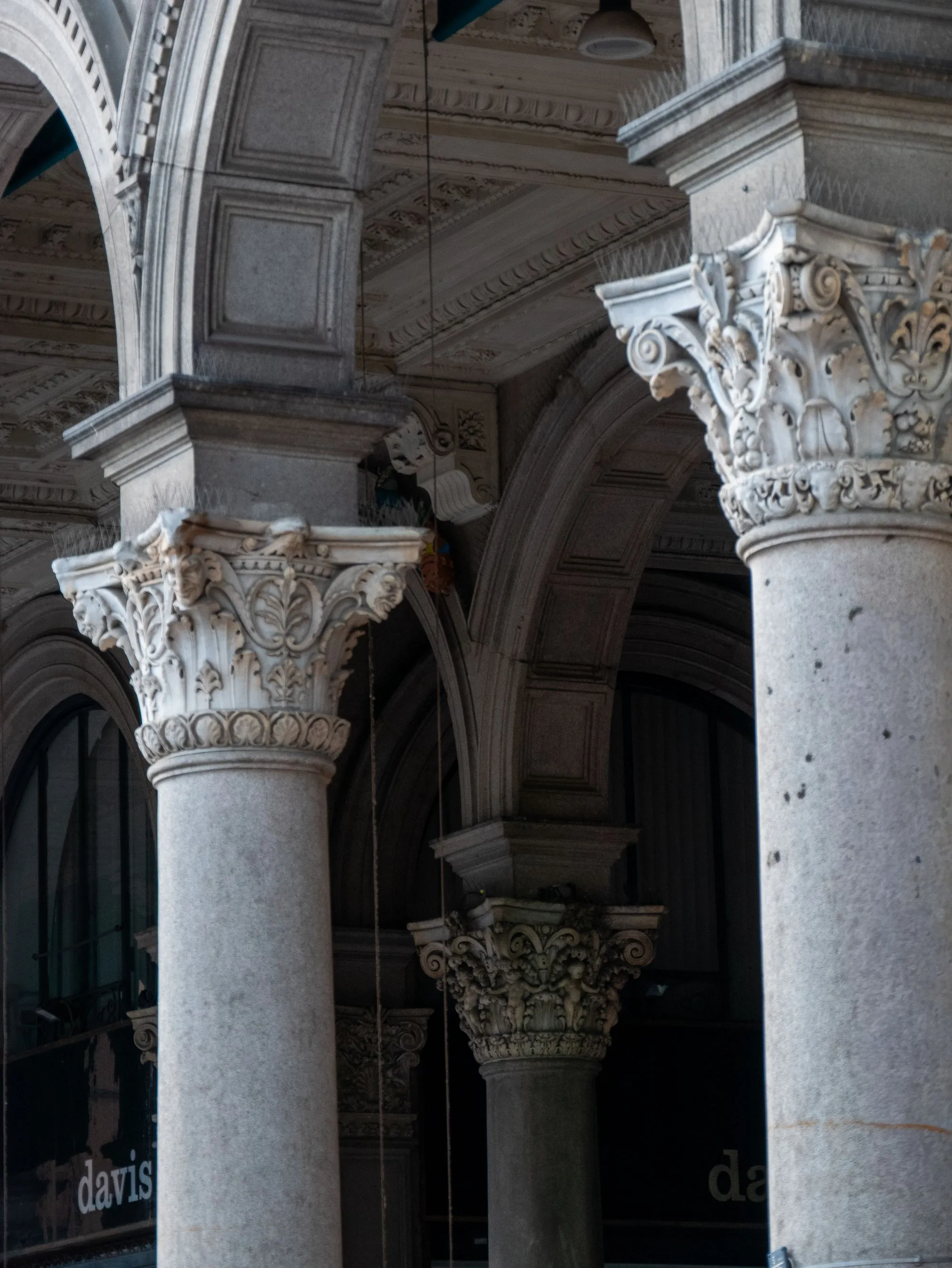 Corinthian stone columns of a classical bank building.