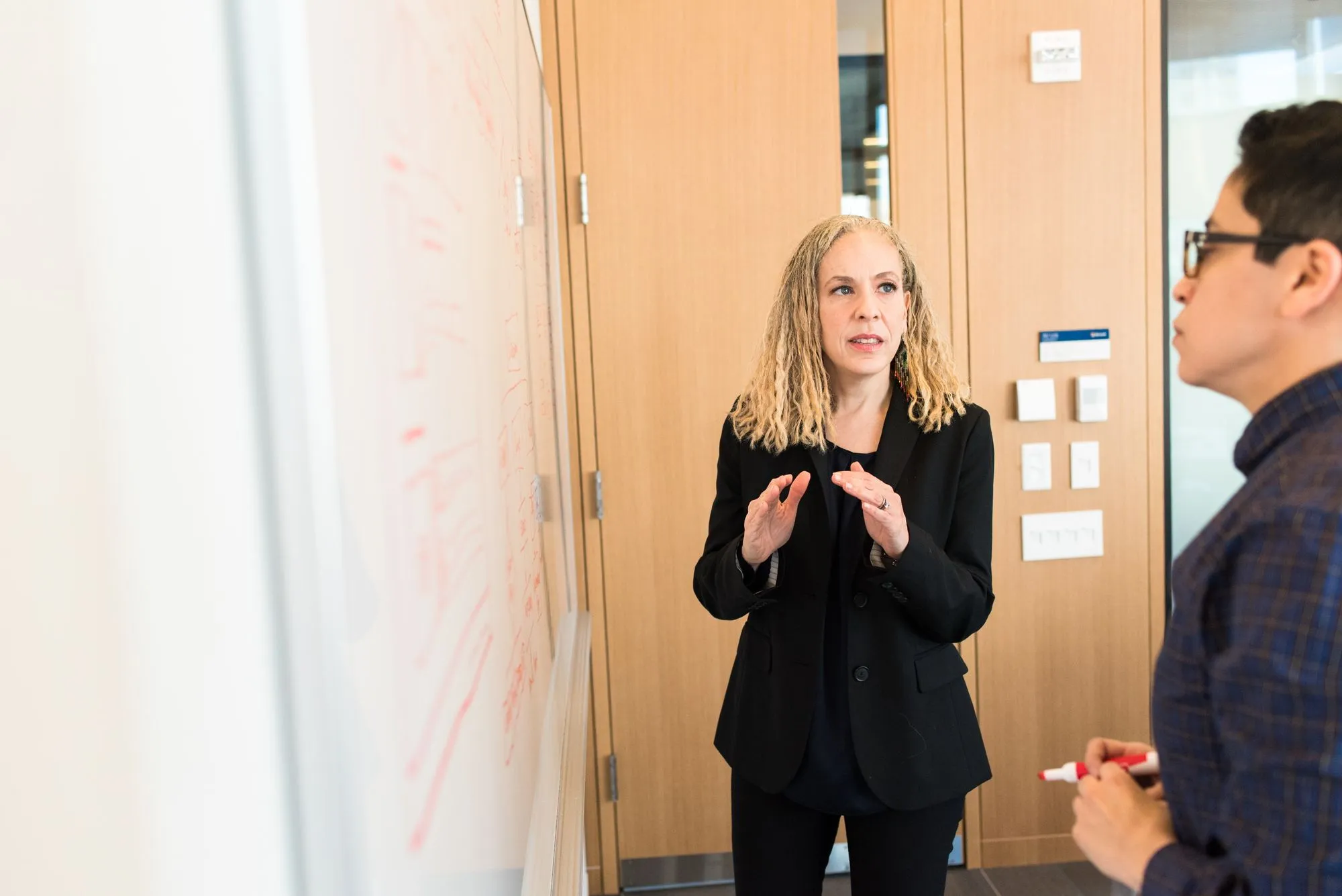 Two professionals in conversation in a bright office.