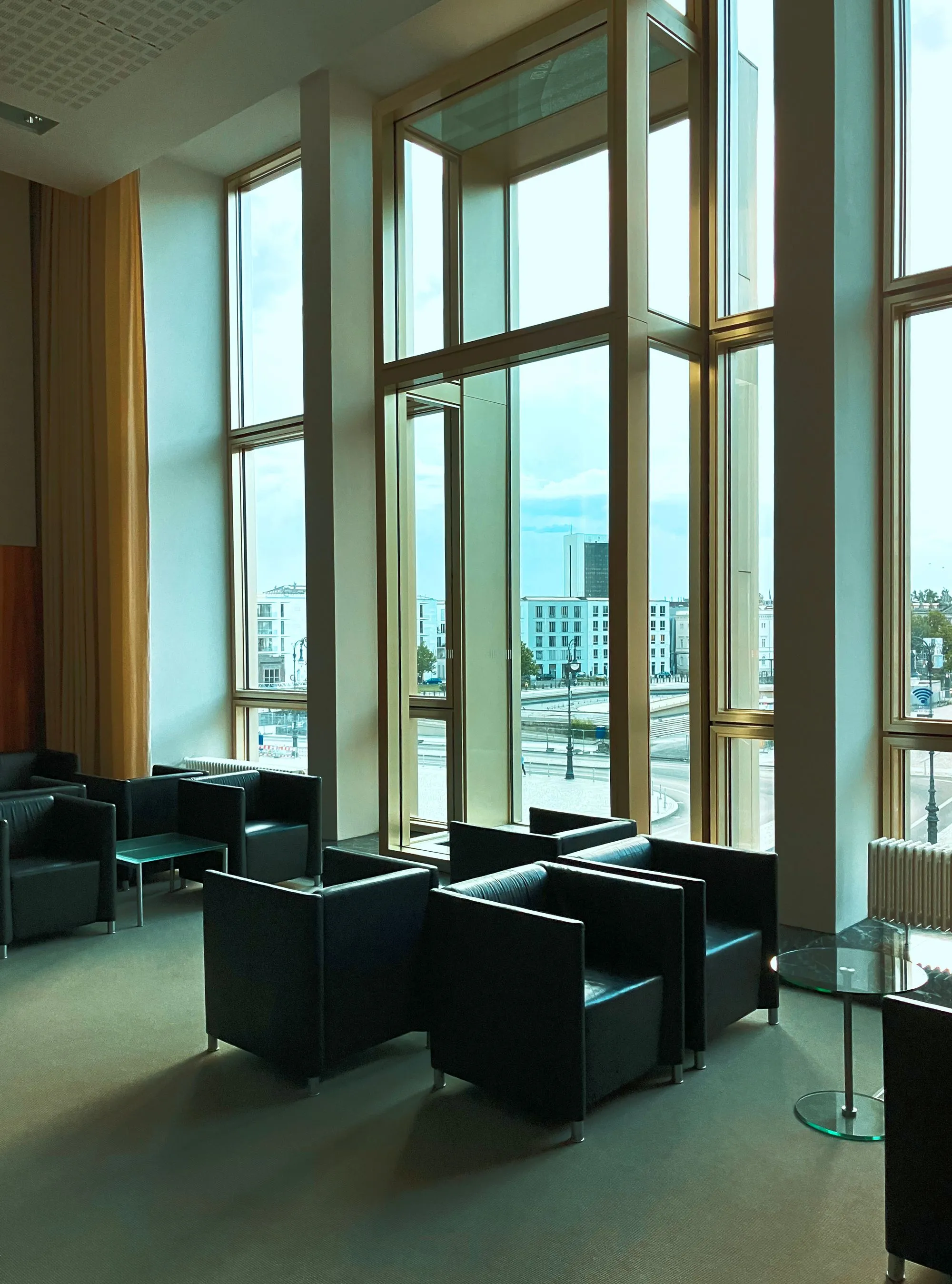 A quiet, wood-paneled lobby with tall windows.